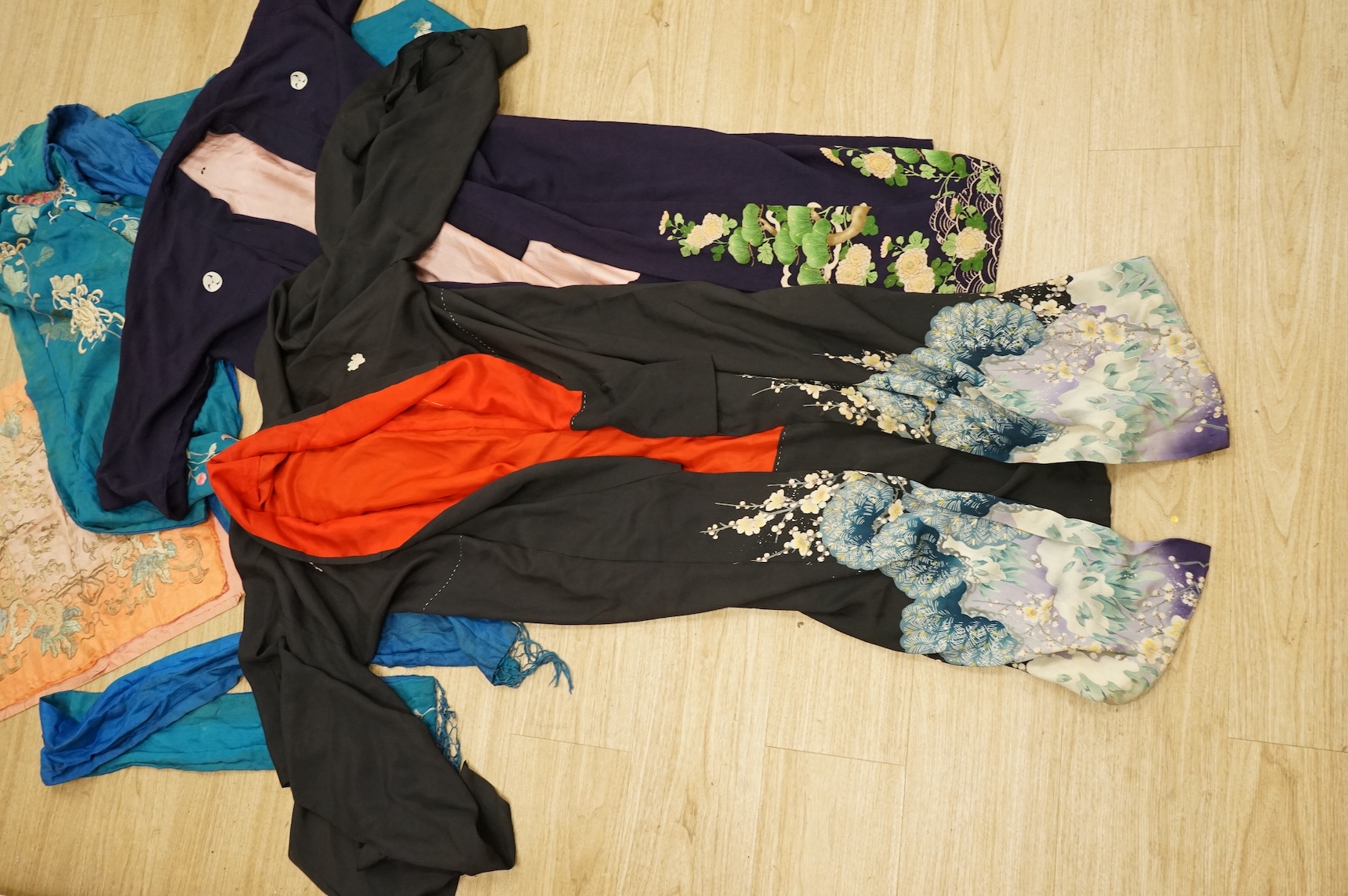 A collection of Chinese and Japanese embroidered kimonos and textiles
